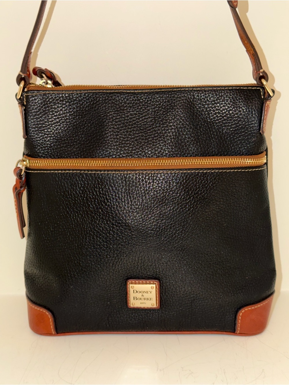 Dooney & Bourke Black Pebbled Leather Crossbody with Brown Trim and Gold Accents